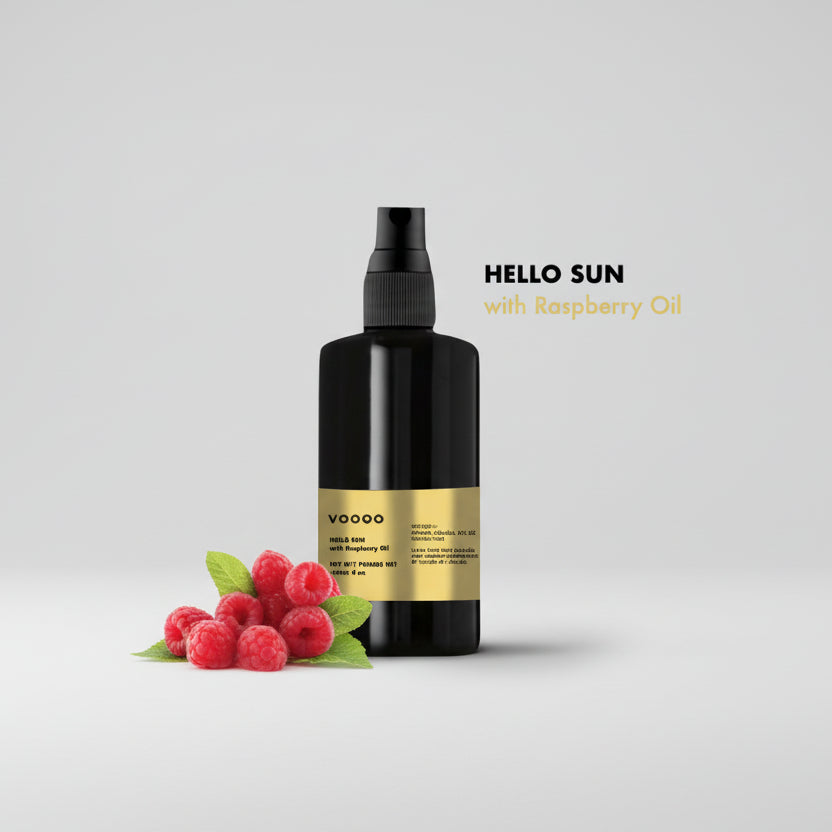 Black spray bottle labeled 'VooCo' with a gold label, surrounded by raspberries on a light gray background.