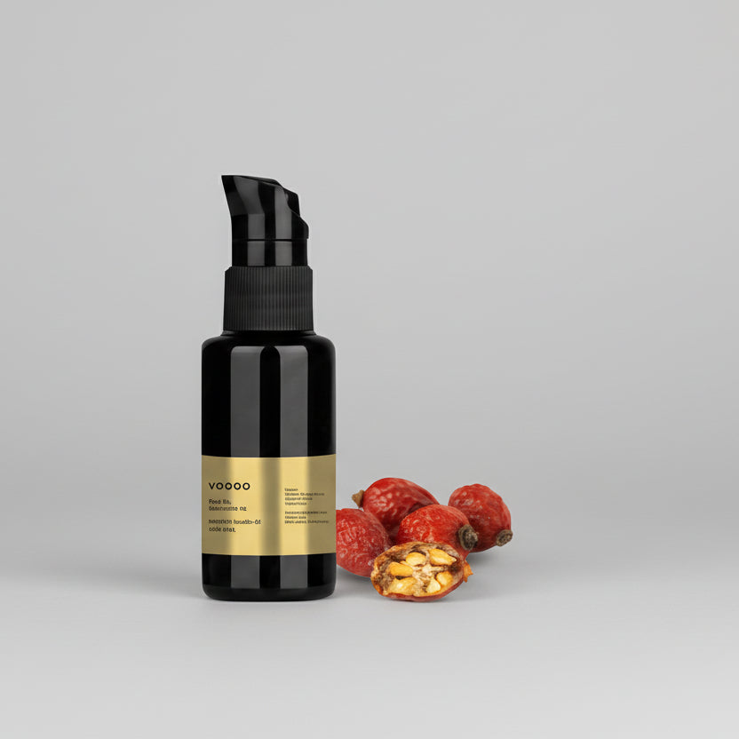 Black face oil bottle with a label and dried fruits on a white background