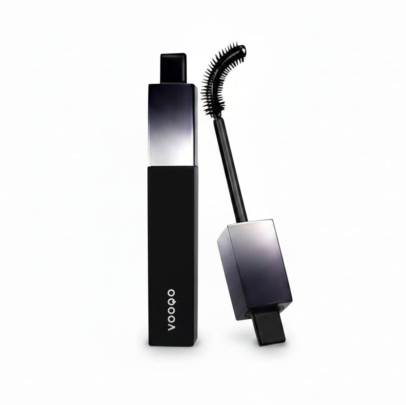 Black mascara with brush on a white background