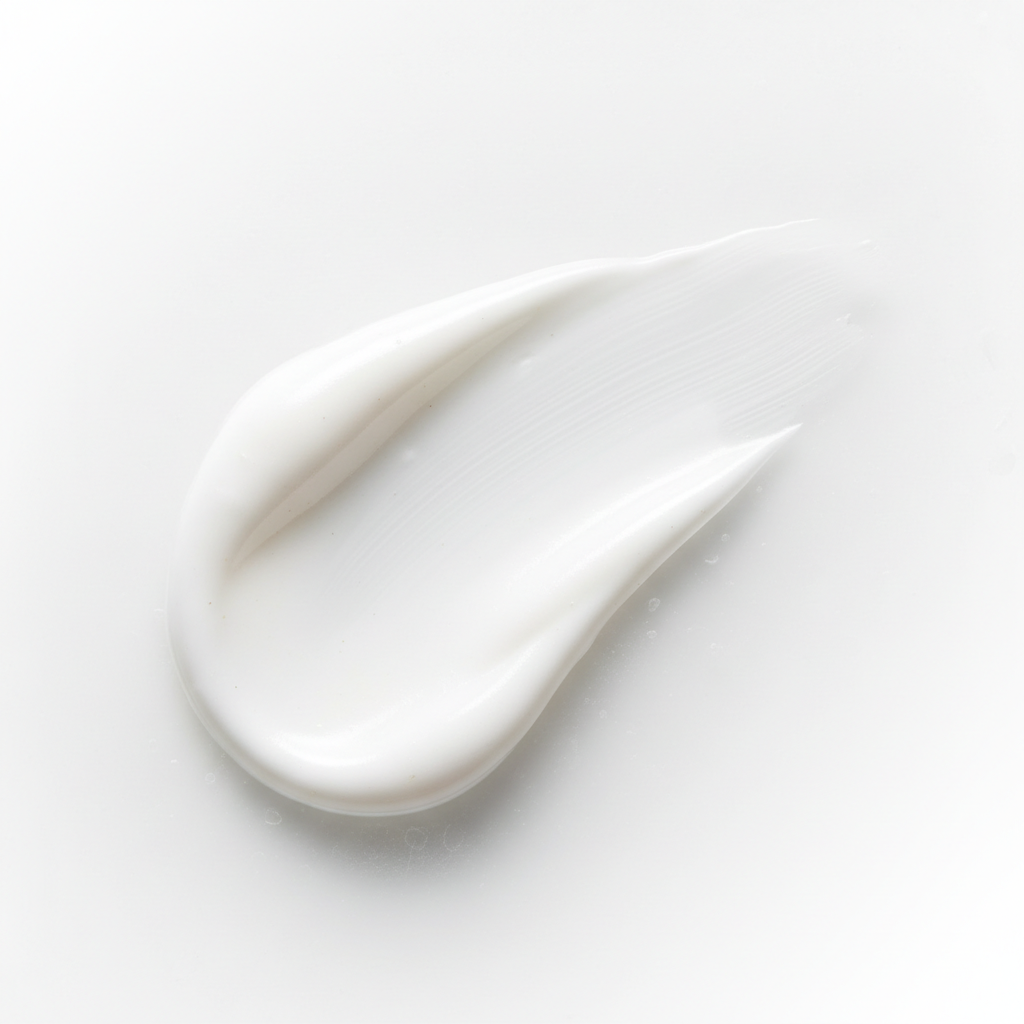 White cream or paint swatch on a light gray background