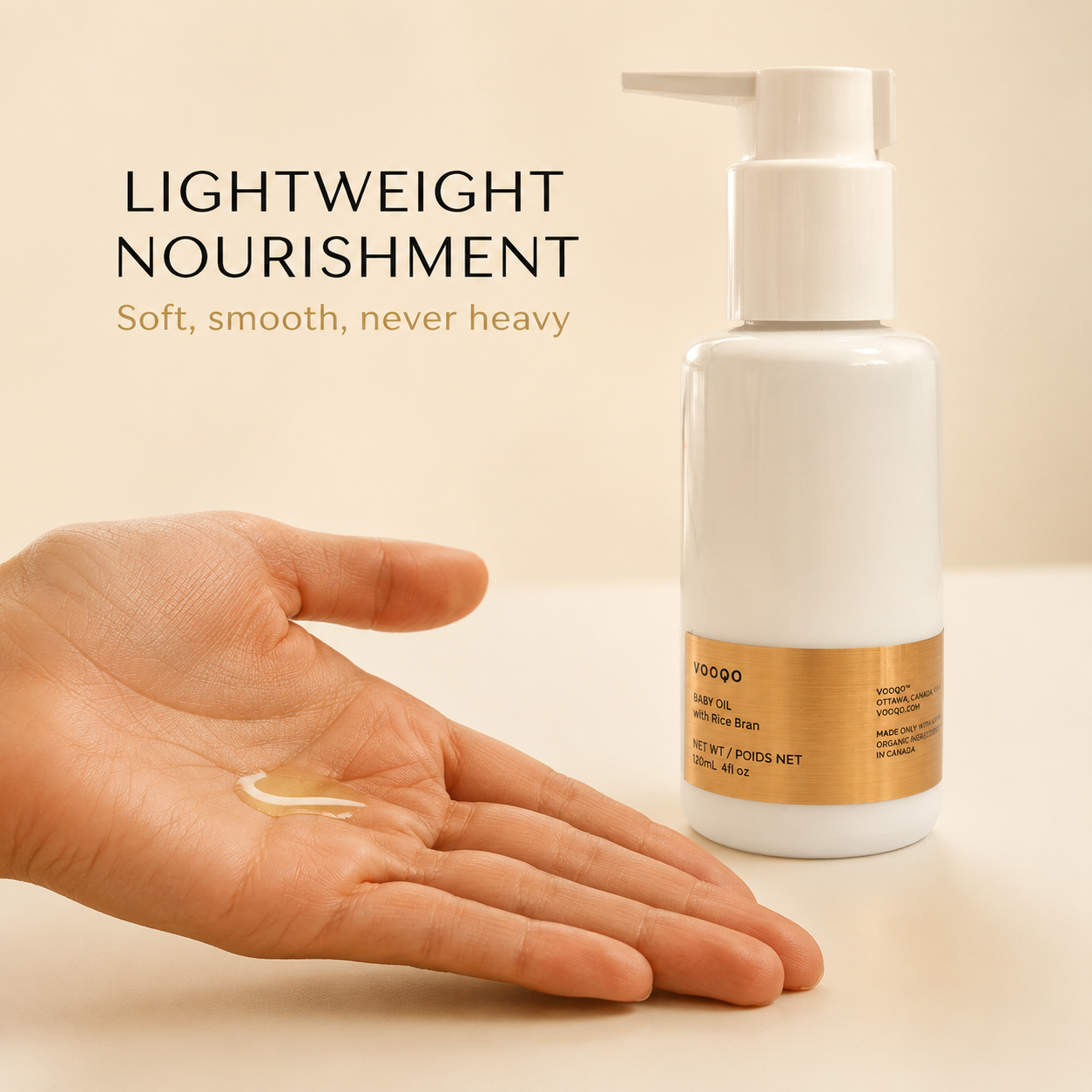 Lightweight Vooqo Baby Oil texture shown on a hand beside the bottle