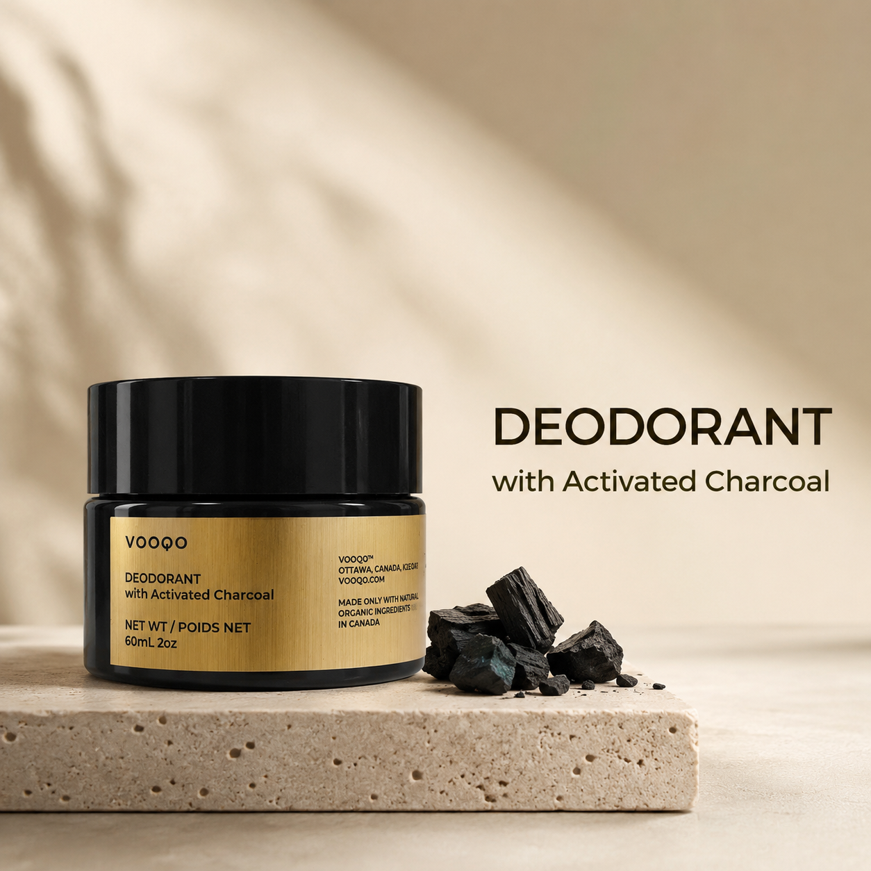 Vooqo Deodorant with Activated Charcoal main product image with black jar, gold label, charcoal pieces, and warm neutral background.