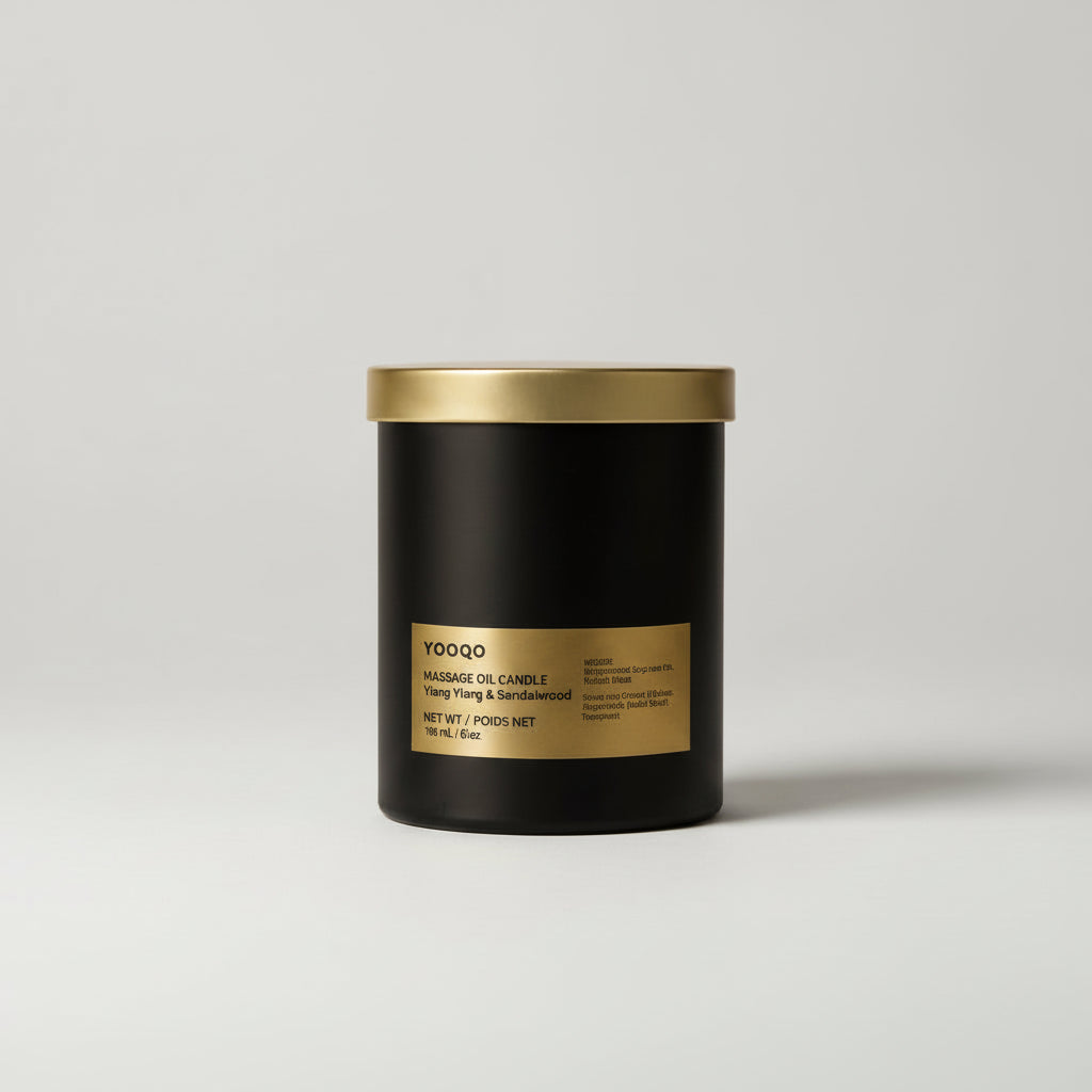 Black candle with gold lid and label on a light gray background
