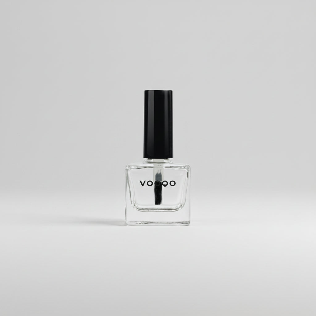 Clear nail polish bottle with black cap on a white background