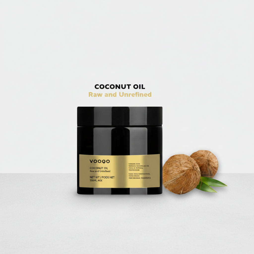 Jar of coconut oil with two coconuts on a light gray background